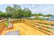 Spacious outdoor deck area with seating that features a wooden railing with views of surrounding trees at 184 Azalea Rd, Edgewater, FL 32141