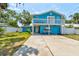 Bright blue two-story home featuring a second-story balcony, quaint curb appeal, and ample parking at 184 Azalea Rd, Edgewater, FL 32141