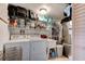 Well-organized laundry room with washer, dryer, shelving, sink, and stainless steel refrigerator at 184 Azalea Rd, Edgewater, FL 32141