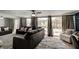 Spacious living room with large windows providing natural light and views of the backyard pool area at 184 Azalea Rd, Edgewater, FL 32141