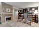 Cozy living room featuring a stone fireplace and built-in shelving, creating a warm and inviting atmosphere at 184 Azalea Rd, Edgewater, FL 32141