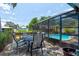 Outdoor patio with table and chairs near the screened pool offering a relaxing entertainment area at 184 Azalea Rd, Edgewater, FL 32141