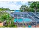 Screened-in pool with lounge seating and well-kept landscaping, perfect for a relaxing swim at 184 Azalea Rd, Edgewater, FL 32141