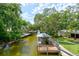 A scenic waterfront view showcasing the canal, docks, and lush greenery surrounding the property at 184 Azalea Rd, Edgewater, FL 32141