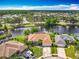 Stunning aerial view of waterfront home with mature trees, lush landscaping, and a serene water view at 1840 Tara Marie Ln, Port Orange, FL 32128