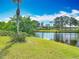 Picturesque water view from the backyard with vibrant green grass and clear blue sky at 1840 Tara Marie Ln, Port Orange, FL 32128