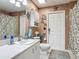 Cozy bathroom featuring a white vanity, toilet, and nautical themed decorations at 1840 Tara Marie Ln, Port Orange, FL 32128