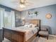 Bedroom featuring a ceiling fan, bed, window, and a comfortable armchair at 1840 Tara Marie Ln, Port Orange, FL 32128
