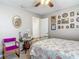 This bedroom features a bed with floral comforter, a table, and decoratively hung pictures at 1840 Tara Marie Ln, Port Orange, FL 32128