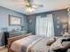 Bedroom featuring a bed, dresser, window, and decoratively placed wall art at 1840 Tara Marie Ln, Port Orange, FL 32128