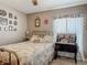 This charming bedroom features a bed with floral comforter, and a brightly lit window at 1840 Tara Marie Ln, Port Orange, FL 32128