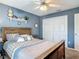 Bright bedroom featuring a ceiling fan, a bed, and a double door closet at 1840 Tara Marie Ln, Port Orange, FL 32128