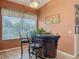 Relaxing dining area with a large window, bar table, and an adjacent open floor plan at 1840 Tara Marie Ln, Port Orange, FL 32128