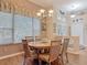 Dining room with wooden table, six chairs, chandelier, and large window at 1840 Tara Marie Ln, Port Orange, FL 32128