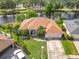 Beautiful waterfront home featuring lush landscaping, well-maintained lawn, and a private driveway at 1840 Tara Marie Ln, Port Orange, FL 32128