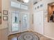 Inviting foyer with decorative tiled floor, high ceilings, and elegant glass-paneled front doors at 1840 Tara Marie Ln, Port Orange, FL 32128