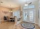 Charming foyer with dining area, decorative tiled floor, high ceilings, and elegant glass-paneled front doors at 1840 Tara Marie Ln, Port Orange, FL 32128