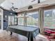 Entertaining game room with a billiard table, large windows overlooking the yard, and stylish decor at 1840 Tara Marie Ln, Port Orange, FL 32128