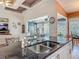 Kitchen with granite countertops, stainless steel faucet, and view of living room at 1840 Tara Marie Ln, Port Orange, FL 32128