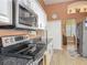Bright and modern kitchen with stainless steel appliances and a view of the dining area at 1840 Tara Marie Ln, Port Orange, FL 32128