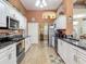 Bright kitchen featuring white cabinets, stainless steel appliances, and access to the dining room at 1840 Tara Marie Ln, Port Orange, FL 32128