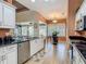 Bright kitchen with granite counters, stainless steel appliances, tile floors, and eat-in dining area at 1840 Tara Marie Ln, Port Orange, FL 32128