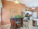 Open kitchen with bar seating, white cabinets, and modern stainless steel appliances at 1840 Tara Marie Ln, Port Orange, FL 32128