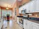Modern kitchen with stainless steel appliances, wood flooring, and easy access to the dining area at 1840 Tara Marie Ln, Port Orange, FL 32128