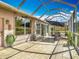 Large tiled lanai with screened enclosure, ideal for relaxing and enjoying the tranquil surroundings at 1840 Tara Marie Ln, Port Orange, FL 32128