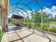 Spacious screened lanai overlooking lush landscaping and peaceful lake at 1840 Tara Marie Ln, Port Orange, FL 32128