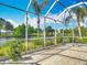 Screened lanai providing serene water views and landscaping at 1840 Tara Marie Ln, Port Orange, FL 32128