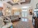 Inviting living room featuring a sectional sofa, stylish rug, and an open layout to the dining area at 1840 Tara Marie Ln, Port Orange, FL 32128