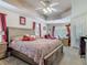 Bright main bedroom suite with a ceiling fan, trey ceiling, carpeting, and access to a sitting area at 1840 Tara Marie Ln, Port Orange, FL 32128