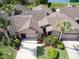 Expansive aerial view of a well-maintained single-Gathering home surrounded by lush greenery and mature palm trees at 1903 Sprucewood Way, Port Orange, FL 32128
