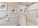 Bright bathroom featuring a glass-enclosed shower, tiled walls, and tasteful decor at 1903 Sprucewood Way, Port Orange, FL 32128