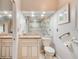 Bright bathroom featuring a granite vanity top, accessible grab bars, and a glass-enclosed shower at 1903 Sprucewood Way, Port Orange, FL 32128