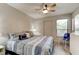 Comfortable bedroom with wood floors, ceiling fan, neutral colors, and slider closet at 1903 Sprucewood Way, Port Orange, FL 32128