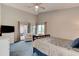 Bright main bedroom with a ceiling fan, large windows, and private access to a screened patio at 1903 Sprucewood Way, Port Orange, FL 32128