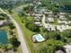 An aerial view showing the community pool near a lake and residential area at 1903 Sprucewood Way, Port Orange, FL 32128