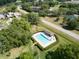 Aerial view of community pool surrounded by lush greenery and landscaping at 1903 Sprucewood Way, Port Orange, FL 32128