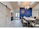 Formal dining room features a long table, stylish chandelier, and a statement blue accent wall at 1903 Sprucewood Way, Port Orange, FL 32128