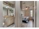 Hallway with a partial bedroom view and granite vanity in an adjacent bathroom, showcasing natural light at 1903 Sprucewood Way, Port Orange, FL 32128