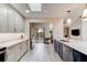 Open kitchen layout with stainless steel appliances, white cabinets, and a view of the patio at 1903 Sprucewood Way, Port Orange, FL 32128