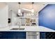 Kitchen features blue cabinets, stainless steel appliances, and an oversized sink with a window view at 1903 Sprucewood Way, Port Orange, FL 32128