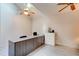 Bright home office with a large desk, wood laminate flooring, and a ceiling fan at 1903 Sprucewood Way, Port Orange, FL 32128