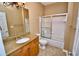 Bathroom with a granite-topped vanity, a sink, a toilet, and a shower with glass doors at 1903 Turnbull Lakes Dr # 1903, New Smyrna Beach, FL 32168