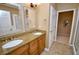 Bathroom with granite countertops, dual sinks, wooden cabinetry, and tile flooring at 1903 Turnbull Lakes Dr # 1903, New Smyrna Beach, FL 32168