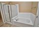 Elegant bathroom featuring a glass-enclosed shower, jacuzzi tub, and tile flooring at 1903 Turnbull Lakes Dr # 1903, New Smyrna Beach, FL 32168