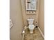 Neutral bathroom with tile floors, toilet, and wicker storage at 1903 Turnbull Lakes Dr # 1903, New Smyrna Beach, FL 32168