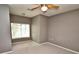 A bedroom with gray carpet features a window with blinds, and a ceiling fan at 1903 Turnbull Lakes Dr # 1903, New Smyrna Beach, FL 32168